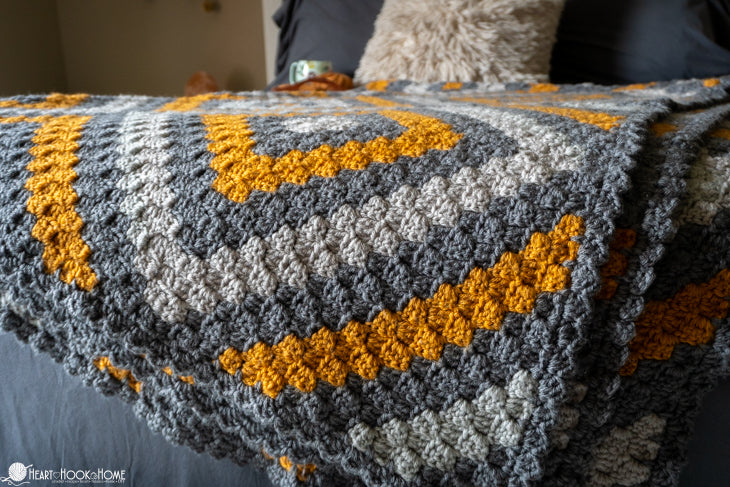 person wrapped in oversized crochet behemoth blanket