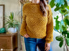 woman wearing wild berry crochet pullover sweater