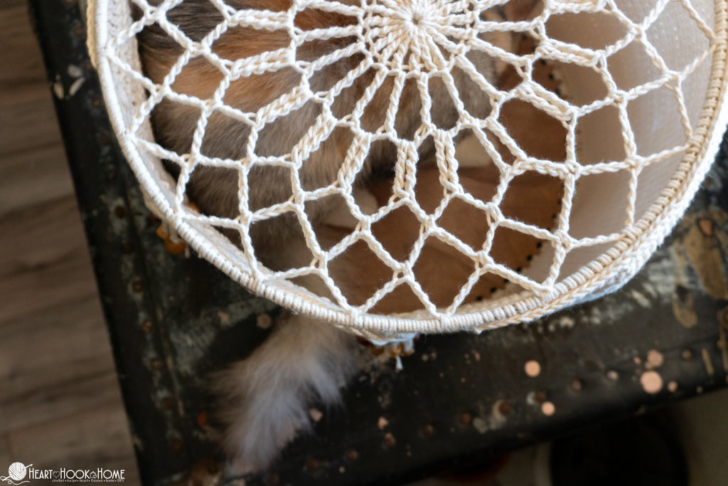 cat resting inside crochet cat cave bed