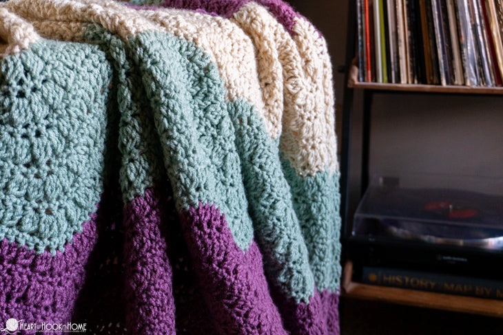 full view cluster ripple crochet blanket draped on couch