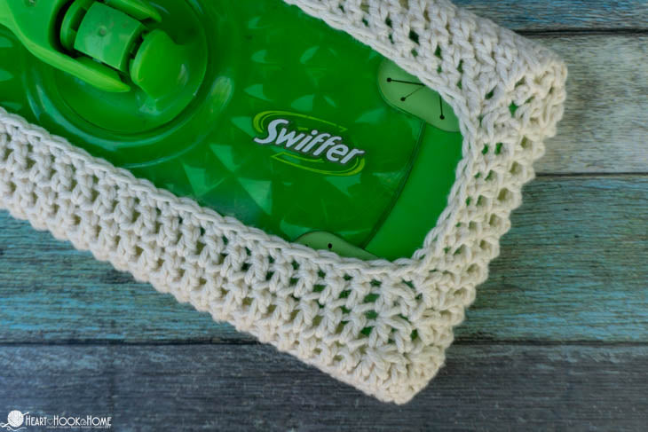 crochet swiffer cover fitted on mop cleaning tool