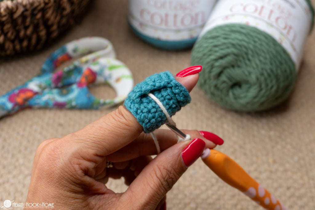 close up crochet finger cuff stitches and fit on finger