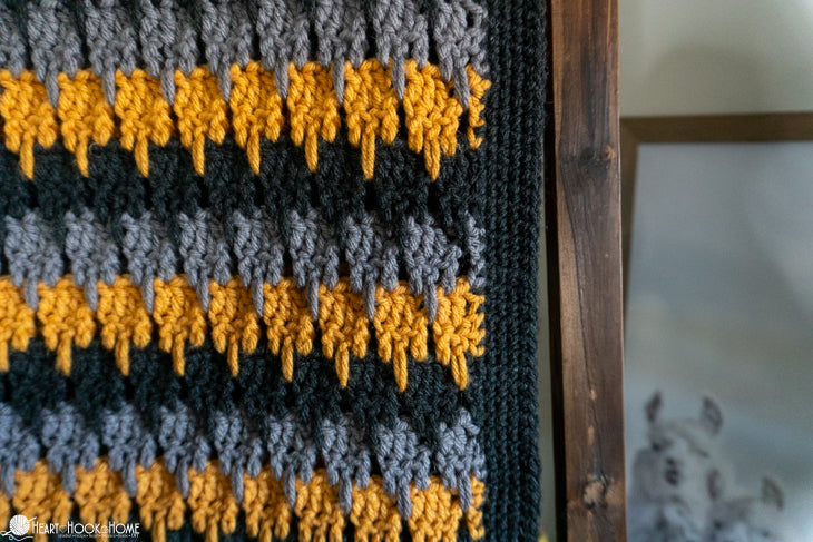 crochet blanket styled in living room cozy throw meadowlark pattern