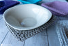 crochet bowl cozy holding hot bowl from microwave