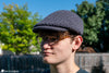 person wearing crochet scally cap newsboy hat