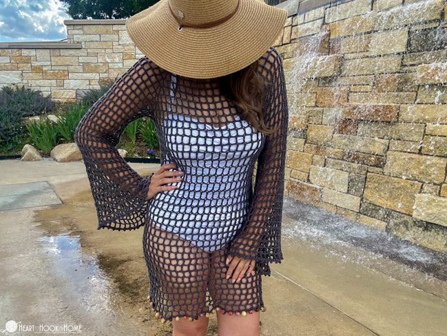woman wearing crochet swimsuit coverup at beach